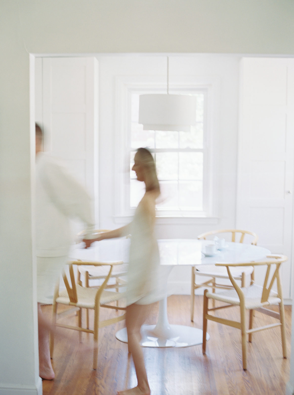 Motion blurred image of couple moving across their kitchen. Lifestyle in-home session in Nashville.
