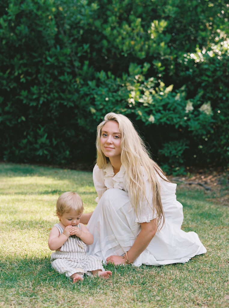 A portrait of Carley Summers next to her son in their backyard