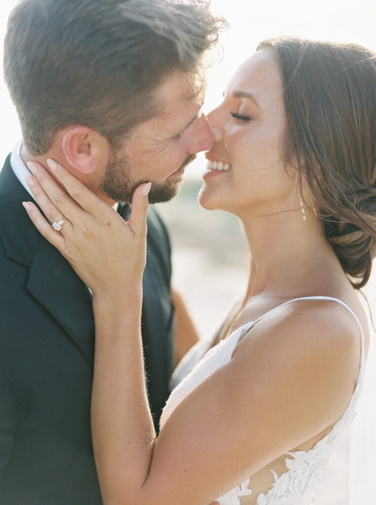Portrait of bride and groom kissing at Sullivan's Island, South Carolina during summer wedding in Charleston