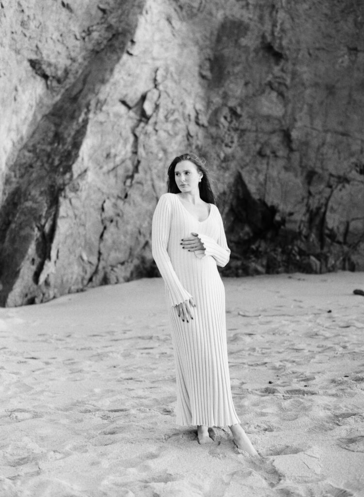 Black and white portrait of mother in long dress celebrating her early maternity with a portrait session in Big Sur
