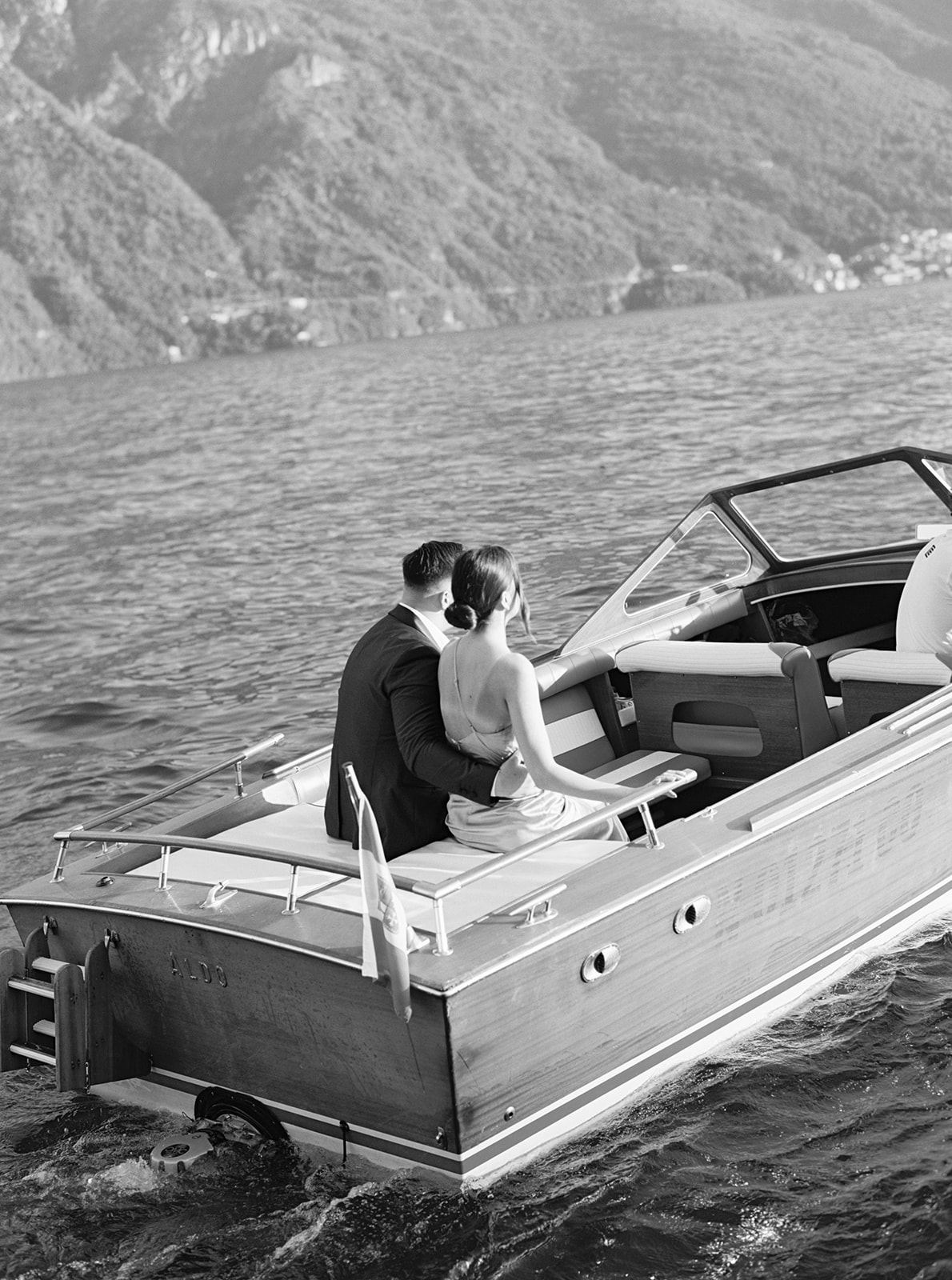 Couple sets sail in a vintage boat on Lake Como for their portrait session