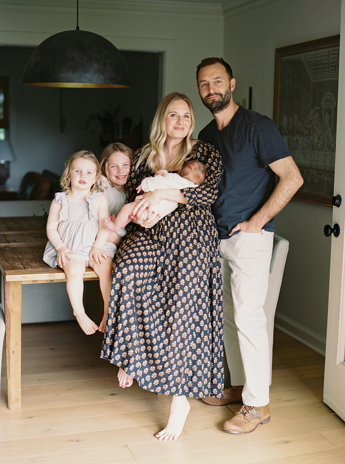 Portrait of family in their home with new baby for an in-home family session