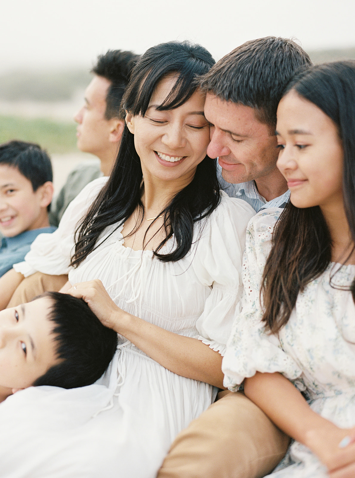 A mom smiles with her kids and husband during her Northern California family session